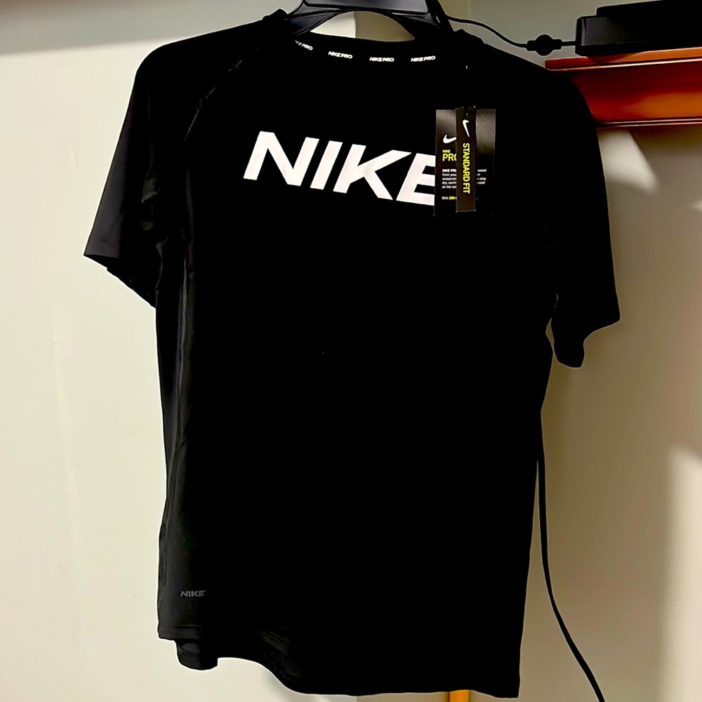Youth Nike activewear black t-shirt has some mesh material under the sleeves.